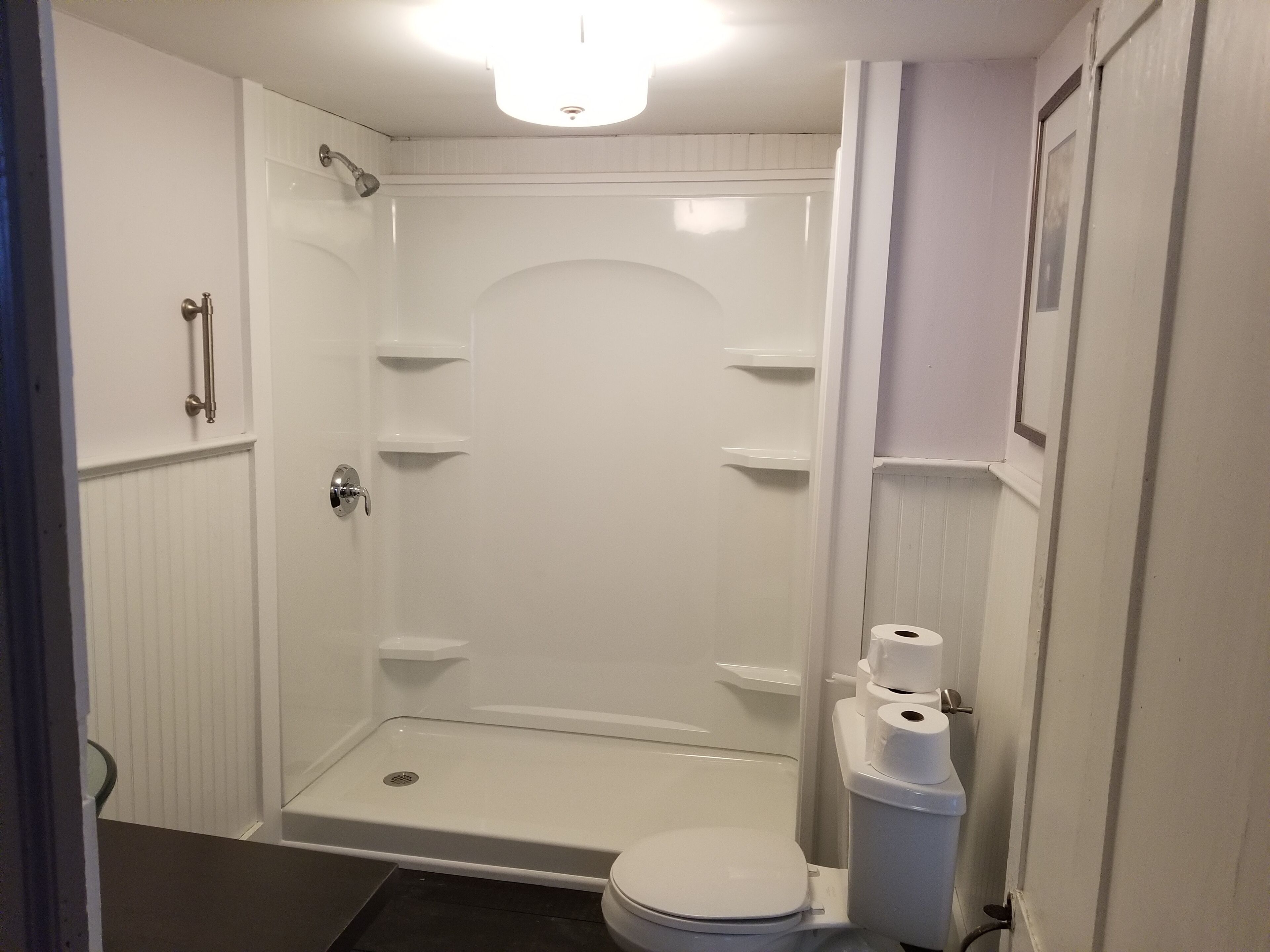 Shower, hair dryer, towels, toilet paper