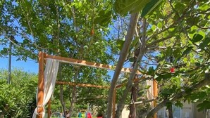 A wooden swing set with a white canopy, surrounded by lush greenery and a well-maintained lawn. - VILLA ZEZE 7 ROOMS 14 SLEEPS PRIVATE WATERSLIDES (Dalyan)