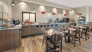 A modern restaurant with a long counter, multiple seating areas, and a variety of food and drink stations. - Best Western Plus Jefferson (Jefferson)