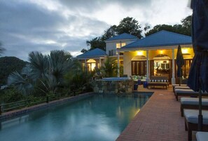A resort with a swimming pool, lounge area, and a covered patio. - Magical Mystic Ridge, 10 min to North Shore Beachs (Coral Bay)