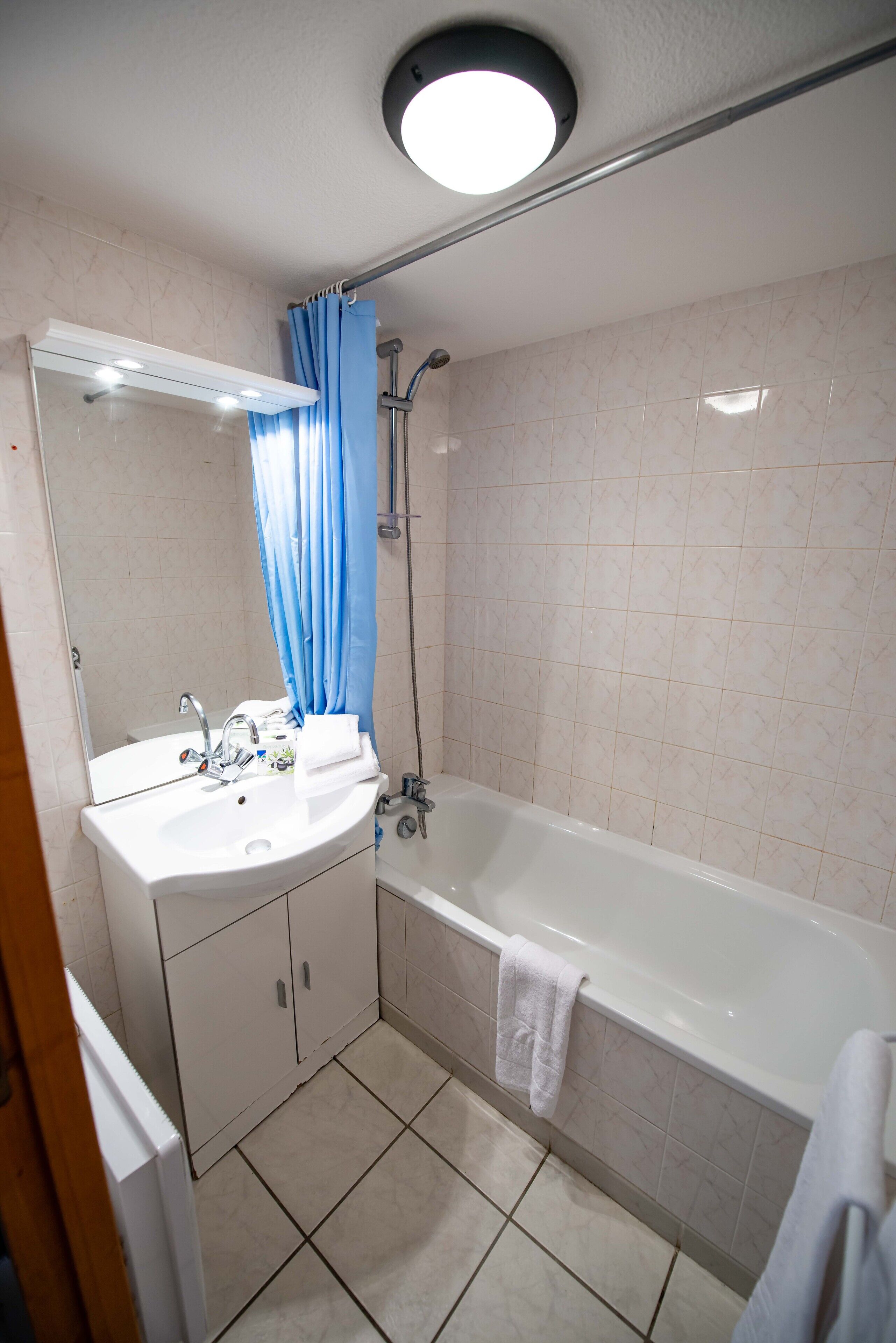 apartment | bathroom | hair dryer, towels