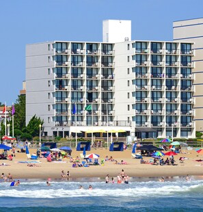 A multi-story hotel with balconies and a beach in the foreground. - The Capes Hotel (Virginia Beach)