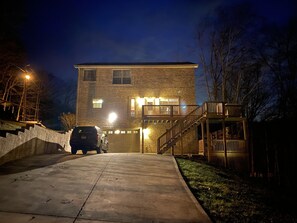 A two-story building with a garage and a staircase leading to a deck. - Falcons Crest at Sequoyah Marina (Norris Lake) (Andersonville)