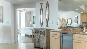 A modern kitchen with a dishwasher, wooden cabinets, and decorative mirrors.