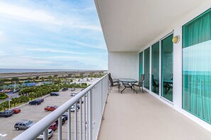 Enjoy a meal or relax on the balcony with a view of the parking lot and distant bridge.