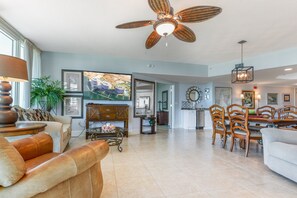 Relax in this inviting living area with a sofa, armchairs, and dining table.