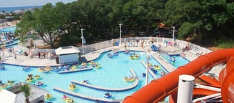 Site MH-59 4BR w/ Covered Patio + TV | Walk to Beach limo golf cart
