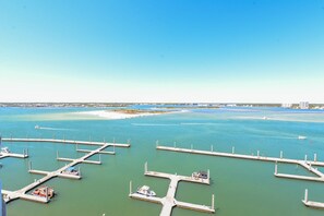 Mooring points for boats line the marina, offering access to the calm waters.