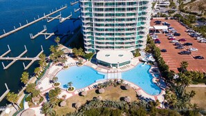 A hotel with a large pool, a marina, and a parking lot. - Exquisite Three Bedroom Condo with Wraparound Balcony and Gulf Views! Complimentary Boat Slip! (Orange Beach)
