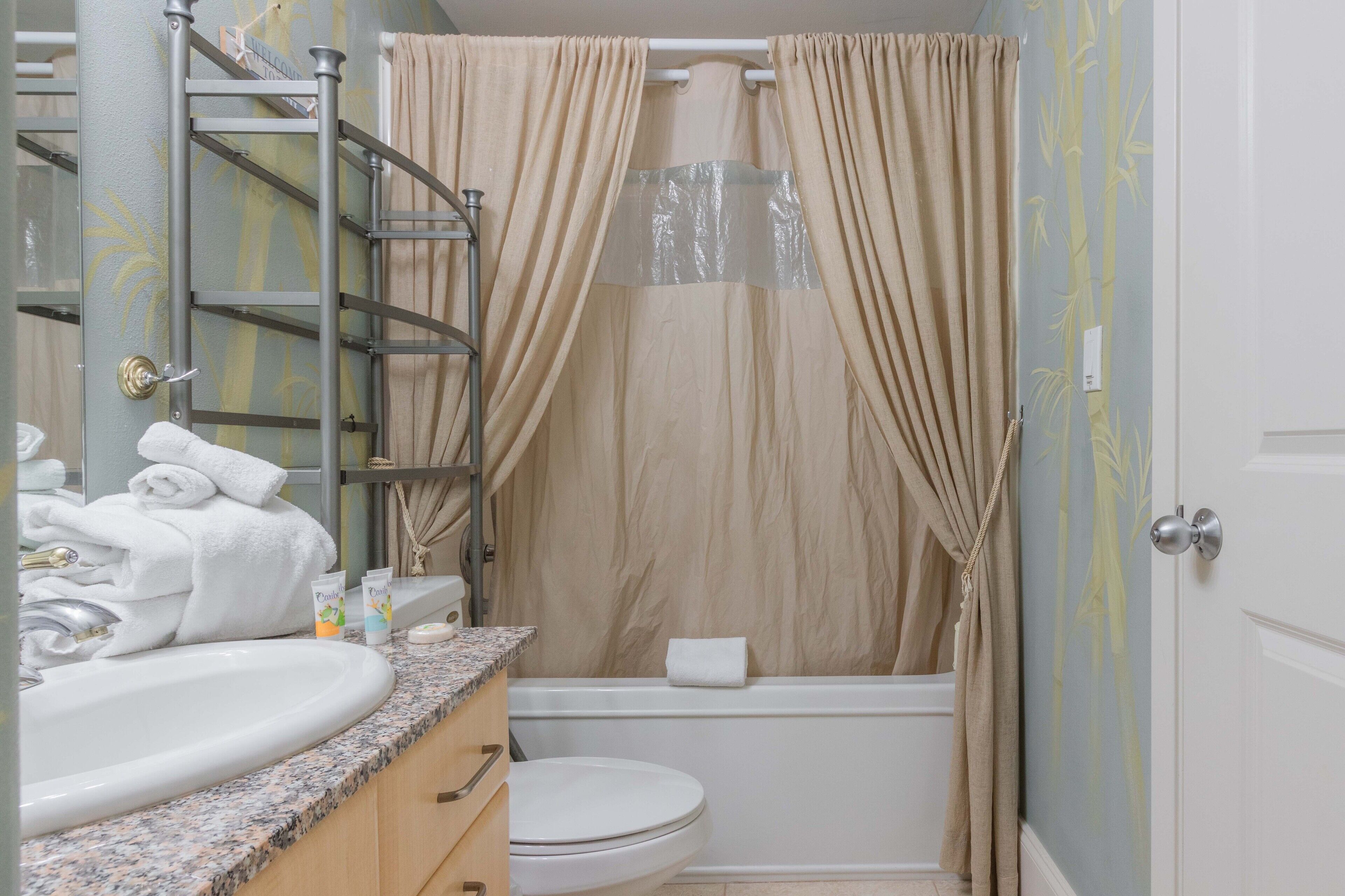 A bathroom with a sink, toilet, and bathtub.