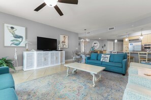 A modern living room with a sofa, coffee table, and a flat-screen TV.