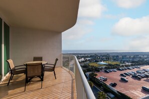 A balcony with a view of a parking lot and a bridge. - Two Bedroom Condo with Gulf and Bay Views! Complimentary Boat Slip! (Orange Beach)
