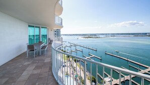 A balcony with a view of the marina and ocean. - Beautiful Family-Friendly Corner Condo with Panoramic Views! Complimentary Boat Slip! (Orange Beach)