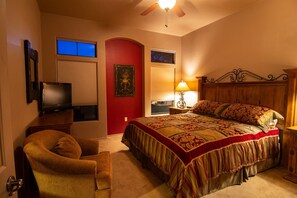 A bedroom with a bed, a chair, a television, and a ceiling fan. - Great condo for exploring Tubac & surroundings! (Tubac)