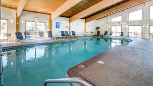 An indoor swimming pool with wooden beams, clear glass walls, and lounge chairs. - Sunset Views over Rachel Carson Preserve. Relax steps from Wells Beach. (Wells)