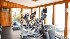 A gym with exercise equipment, a large window, and a wooden interior. - Sunset Views over Rachel Carson Preserve. Relax steps from Wells Beach. (Wells)