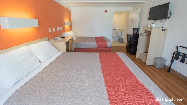 A hotel room with two beds, a TV, a desk, and a wardrobe. - Super 8 By Wyndham Asheville Biltmore (Asheville)