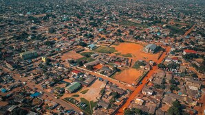 An aerial view of a densely populated urban area with a mix of residential and commercial buildings, roads, and open spaces. - Room-double Room With Sitting Area (Accra)