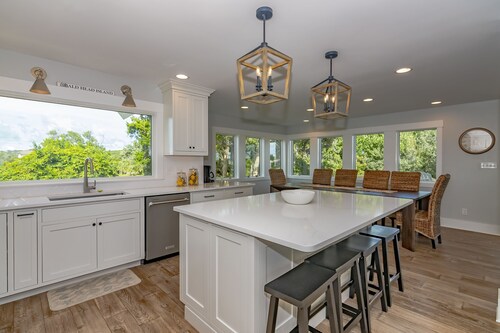 Large home with golf course view, open concept in living room with balcony