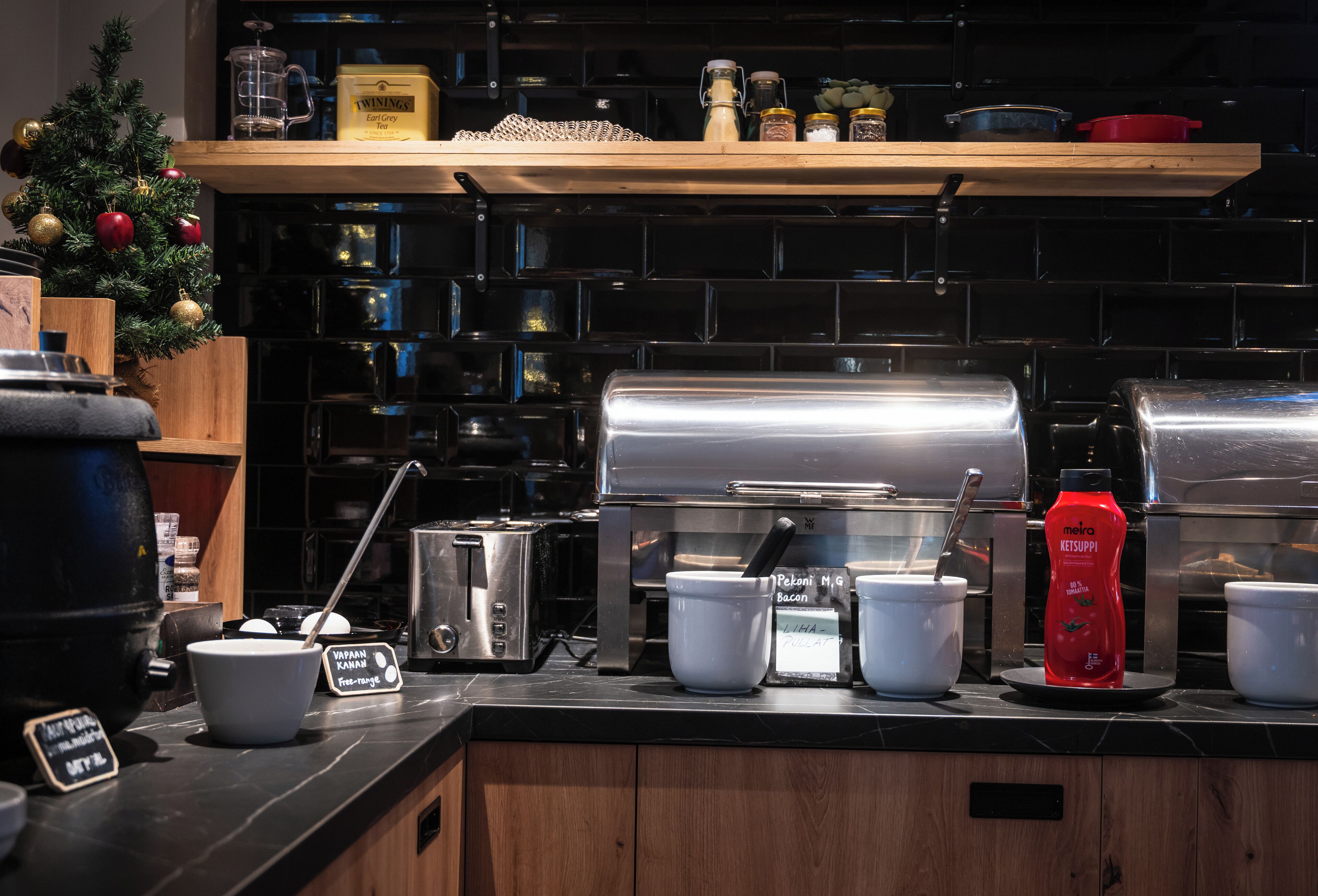 A kitchen with a coffee machine, a toaster, and various cooking utensils.