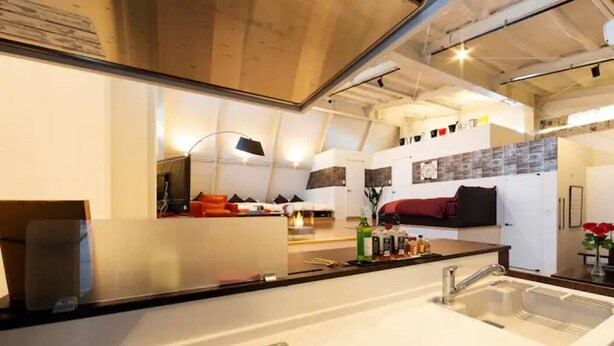 A modern kitchen with a large island, white countertops, and a stainless steel sink. - Ms Studio (Asahikawa)