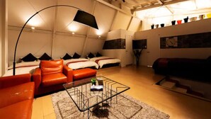 A modern living room with a sofa set, a coffee table, and a floor lamp. - Ms Studio (Asahikawa)