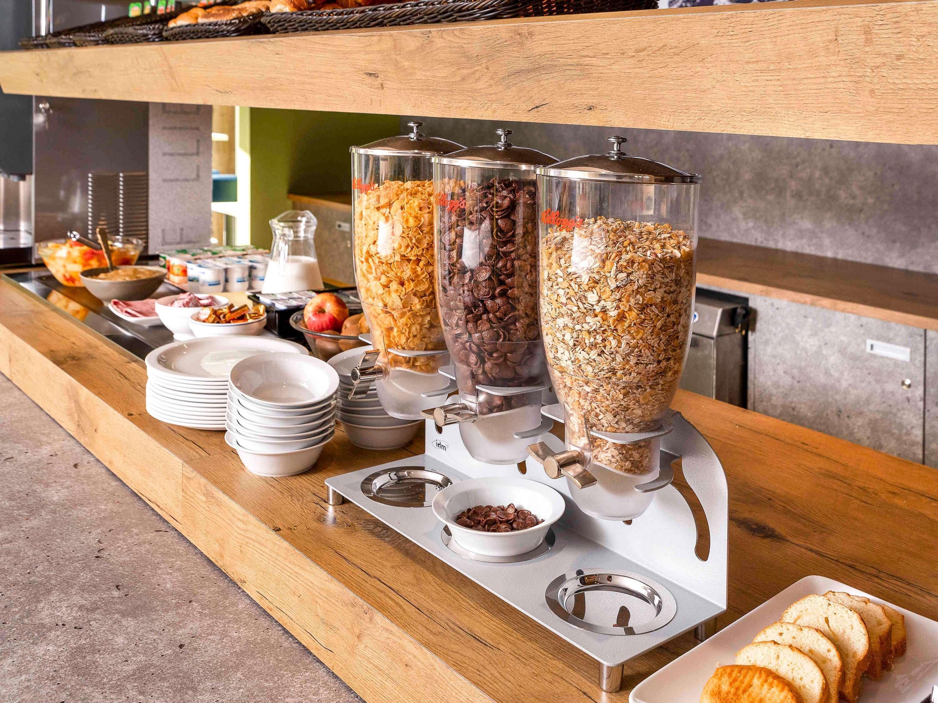 A buffet setup with various food items and a coffee machine.