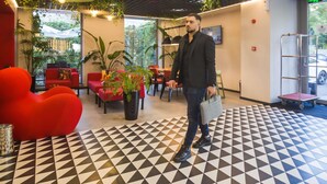 A modern interior with a geometric patterned floor, red seating, and indoor plants. - ibis Bucharest Politehnica (Bucharest)