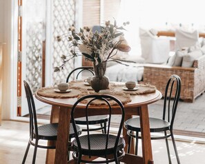 Enjoy meals and social gatherings in this inviting dining area with a round table and comfortable seating.
