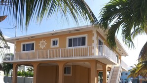A two-story building with a balcony and a ship wheel decoration. - Key Largo Getaway (Key Largo)