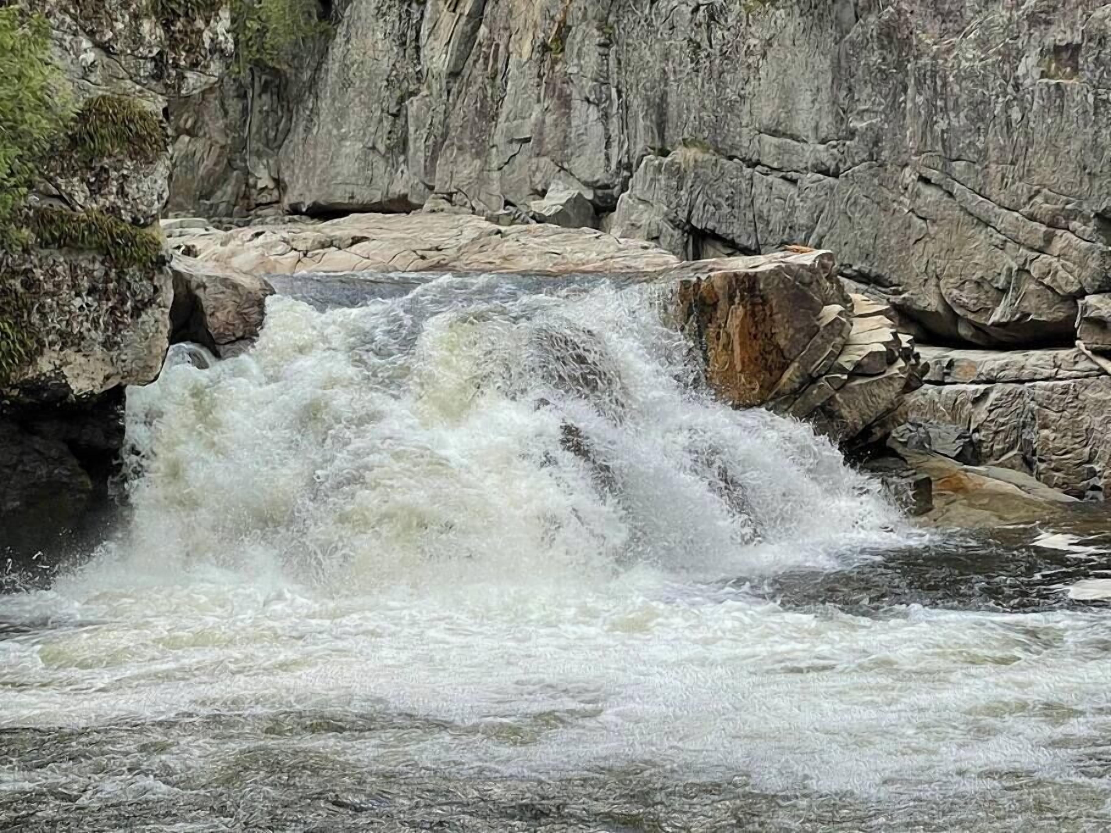 A waterfall cascading over rocky terrain.