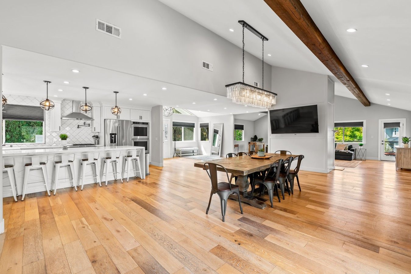 A spacious kitchen with a large island, modern appliances, and pendant lighting.