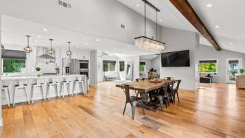 A spacious kitchen with a large island, modern appliances, and pendant lighting.