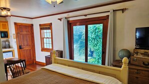 A bedroom with a bed, a wooden dresser, a globe, and a television. - Oak Hill Inn, cozy boutique hotel only a 5min stroll to the heart of Julian!! (Julian)