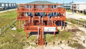 A multi-story building with a prominent red structure in the foreground, likely a lifeguard tower, and a sign indicating it is the Ocean View Dream Resort.