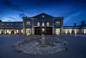 A historic building with a central entrance, large windows, and a cobblestone courtyard. - Station Side Penthouse (Wolverhampton)