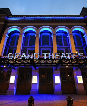 The exterior of a building with a marquee sign reading "GRAND THEATRE". - Station Side Penthouse (Wolverhampton)