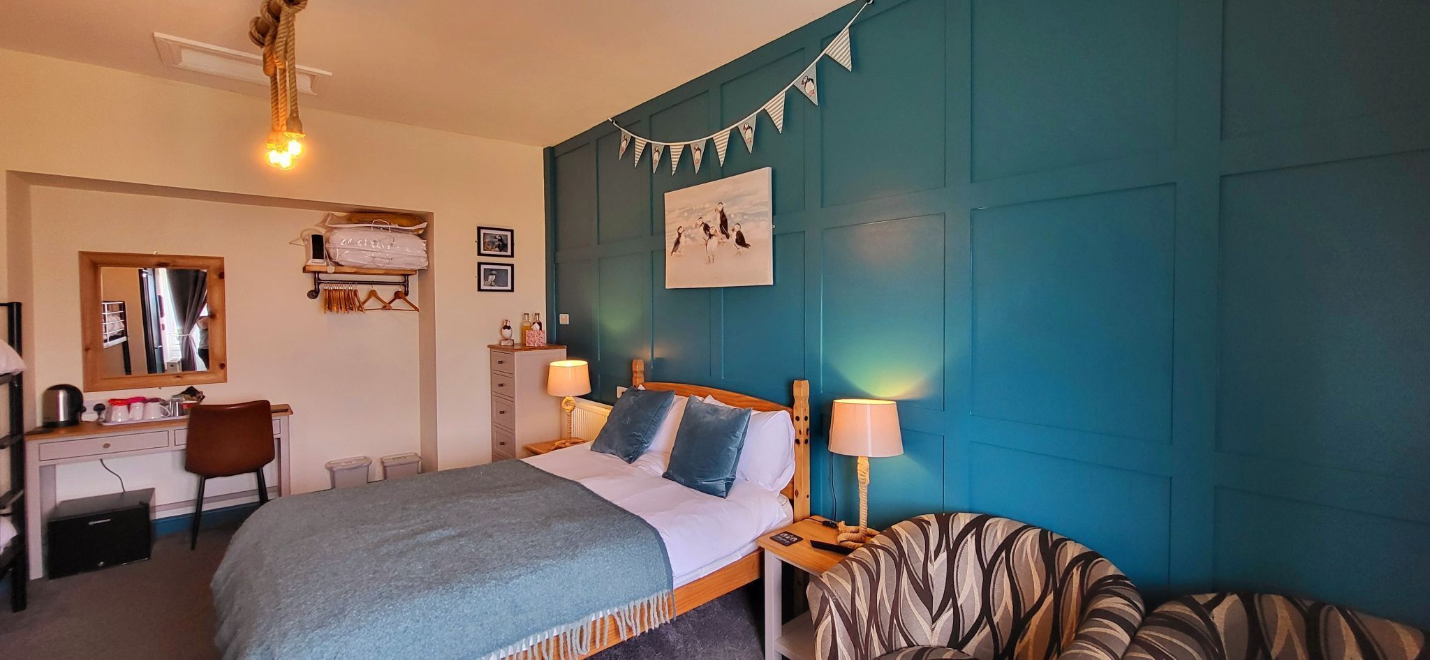 Ein Schlafzimmer mit Bett, Nachttischen, Schreibtisch und Stuhl.