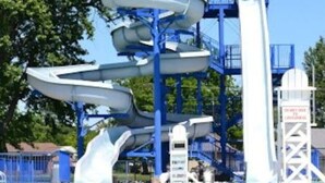 A water park with multiple water slides and a clear blue sky. - Dexter Victorian Homestead- Brand NEW Remodel April 2026. VERY Clean & Cozy (Dexter)