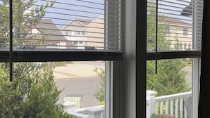 A room with two windows, each with white blinds. - Comfy, Remodeled Beach House with Vintage Jersey Shore Charm (Lavallette)