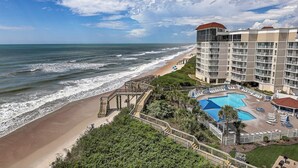A beachfront hotel with a pool, ocean view, and a staircase leading to the beach. - Top floor, oceanfront views! (North Topsail Beach)