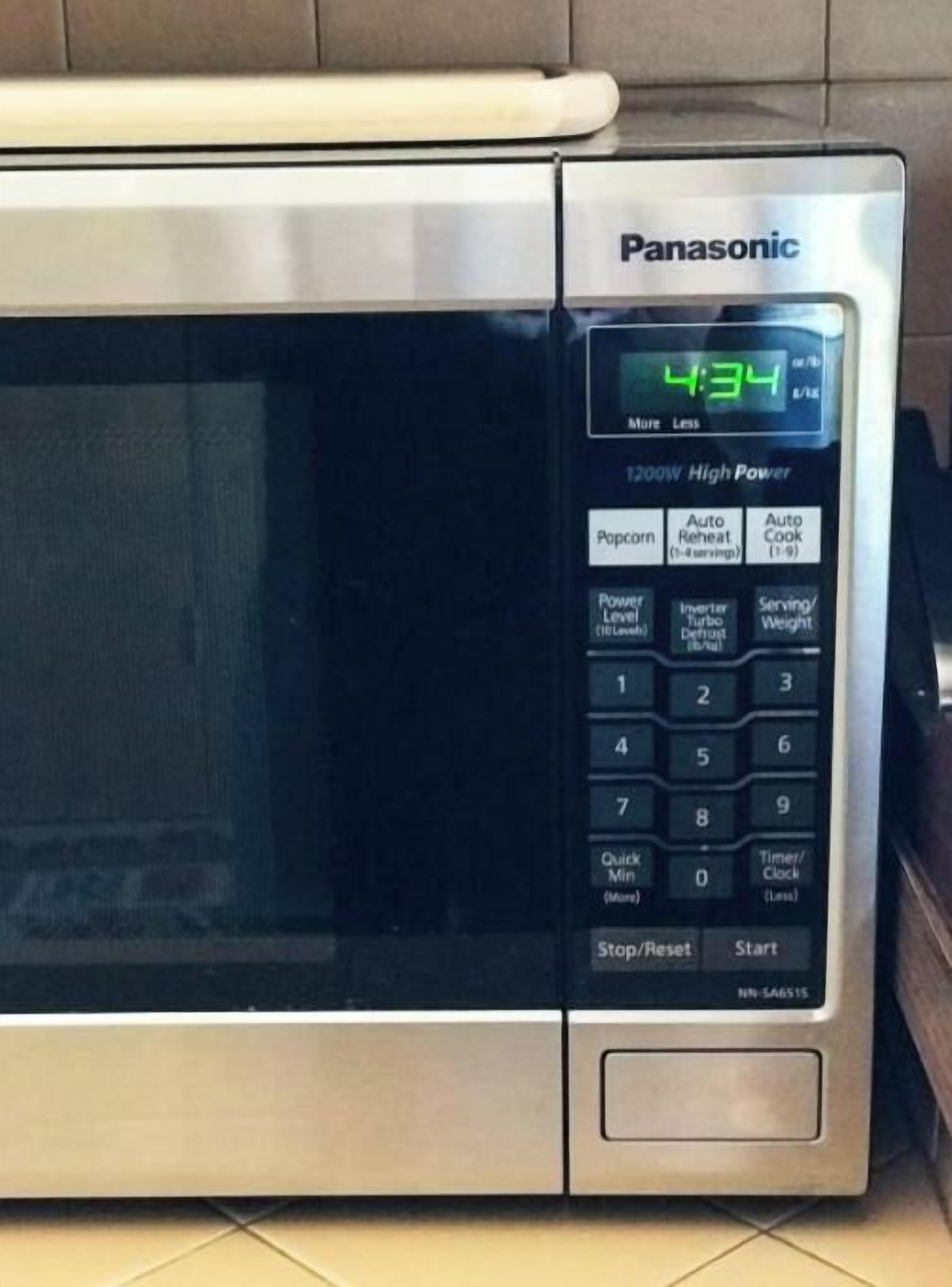 A Panasonic microwave with a digital display, control panel, and buttons for various functions.