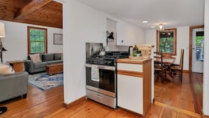 A compact living space with a kitchenette, a dining area, and a sofa. - Brewster Retreat Near Bay Beaches & Dining (Brewster)