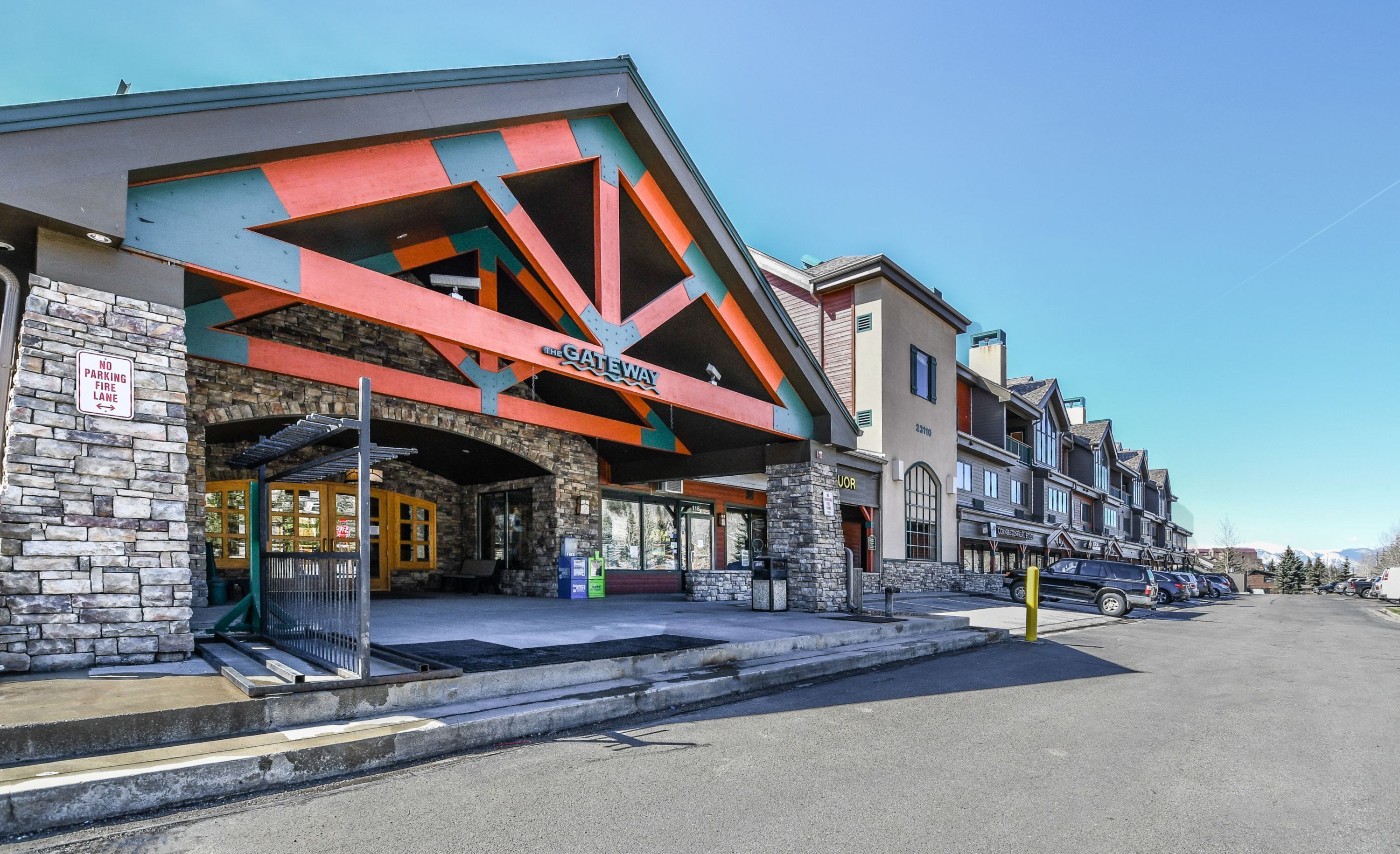 A hotel with a stone facade and a colorful entrance.