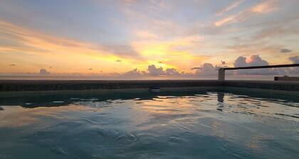 The Sol Studio Suite with balcony overlooking the pool and garden area
