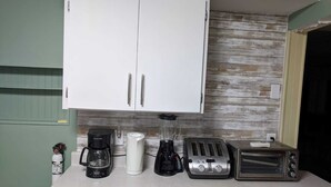 A kitchen with a white cabinet, a coffee maker, a blender, two toasters, and a toaster oven on the counter. - Amazing Mattawa Riverfront, Mountain View Home, Close to Adventures & Amenities (Mattawa)