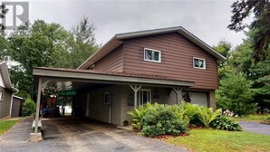 A two-story house with a covered garage and a front porch. - Amazing Mattawa Riverfront, Mountain View Home, Close to Adventures & Amenities (Mattawa)
