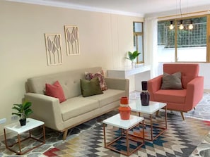 Exclusive Triple Room | Living area | Flat-screen TV