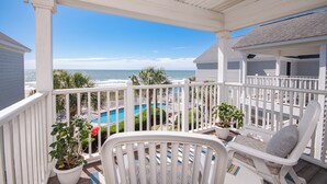 A balcony with a view of the ocean and a pool. - Portofino I 1424 - Oceanfront in Garden City Beach (Garden City Beach)