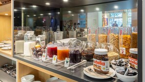 A breakfast buffet with various food items and beverages.